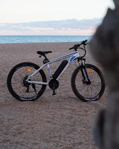 Fafrees F28 electric mountain bike partially assembled with tools nearby.